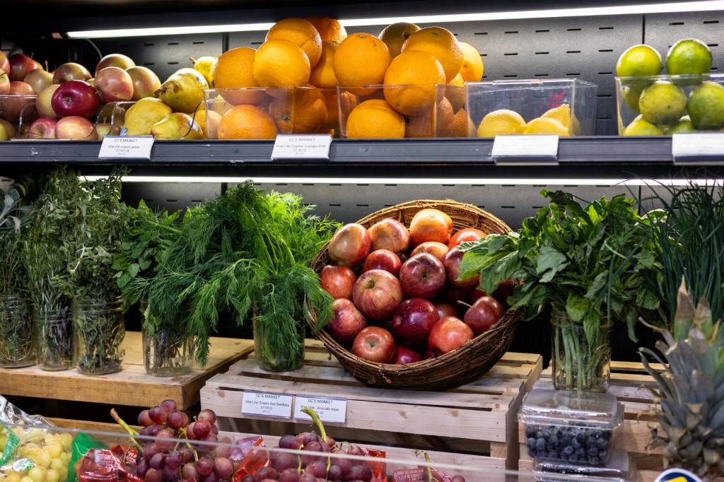 Fresh organic produce, herbs, and fruit on the shelves at CC's Market